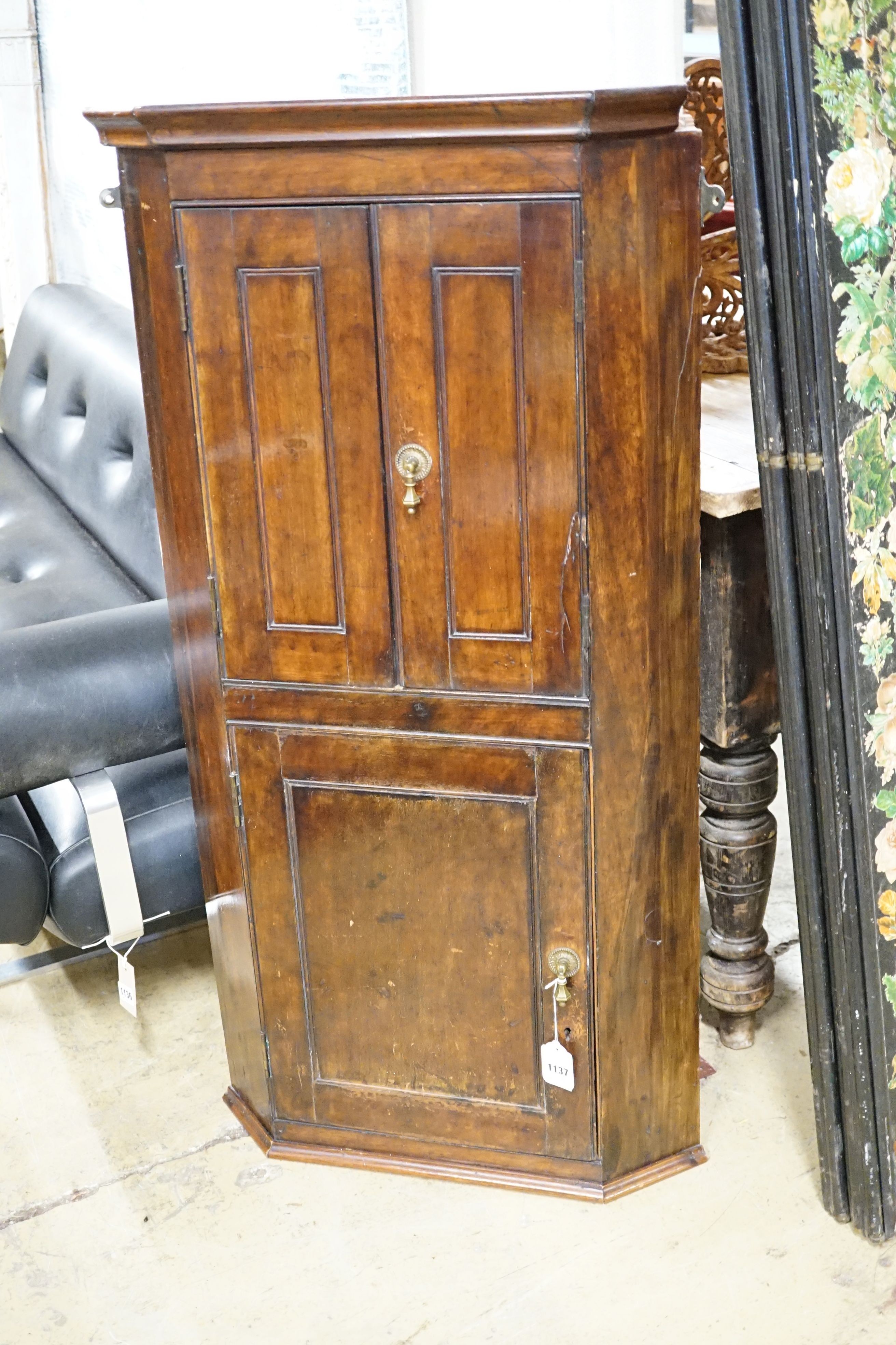An Edwardian mahogany three door hanging corner cupboard, width 60cm, height 113cm